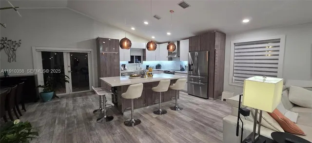a large kitchen with a table and chairs in it