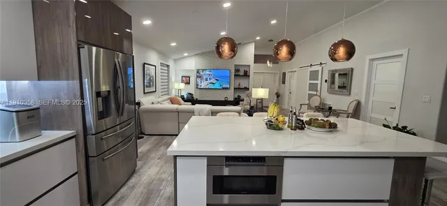 a kitchen with a sink appliances and cabinets