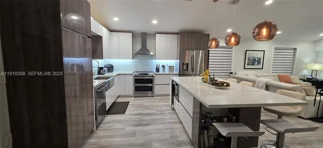 a kitchen with cabinets a sink and appliances