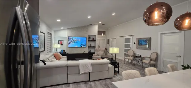 a living room with furniture and a mirror