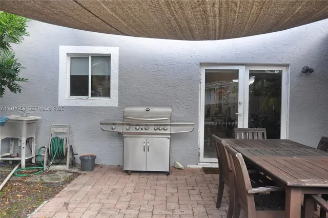 a view of a patio with table and chairs