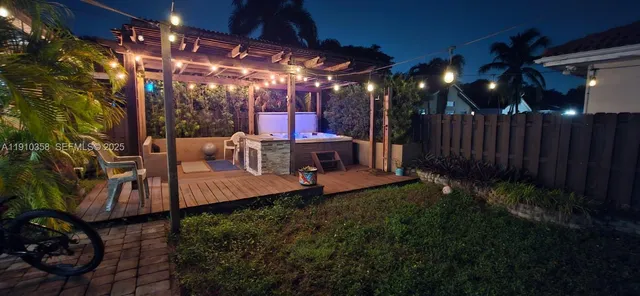 a view of a porch with chairs and potted plants
