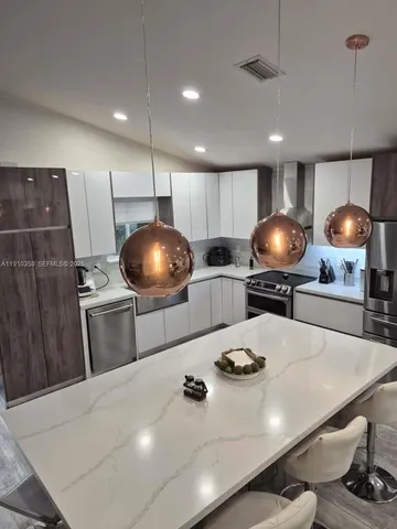 a kitchen with a sink a stove and cabinets