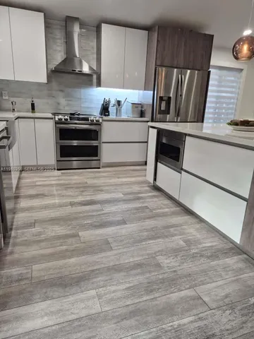 a kitchen with granite countertop a stove and cabinets