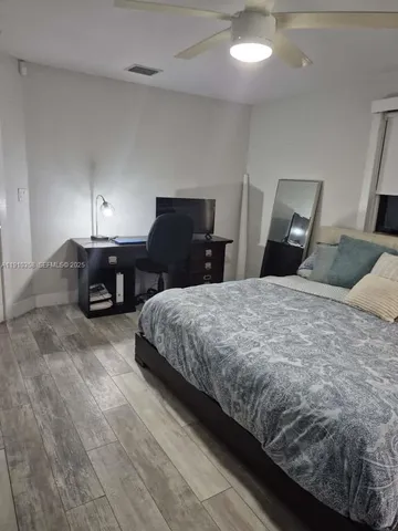 a bedroom with a bed and a table