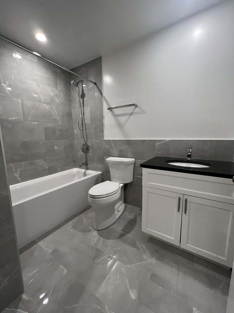 Undisclosed Address Chicago, IL 60640 - Photo 12 of 15 a bathroom with a bathtub and a shower
