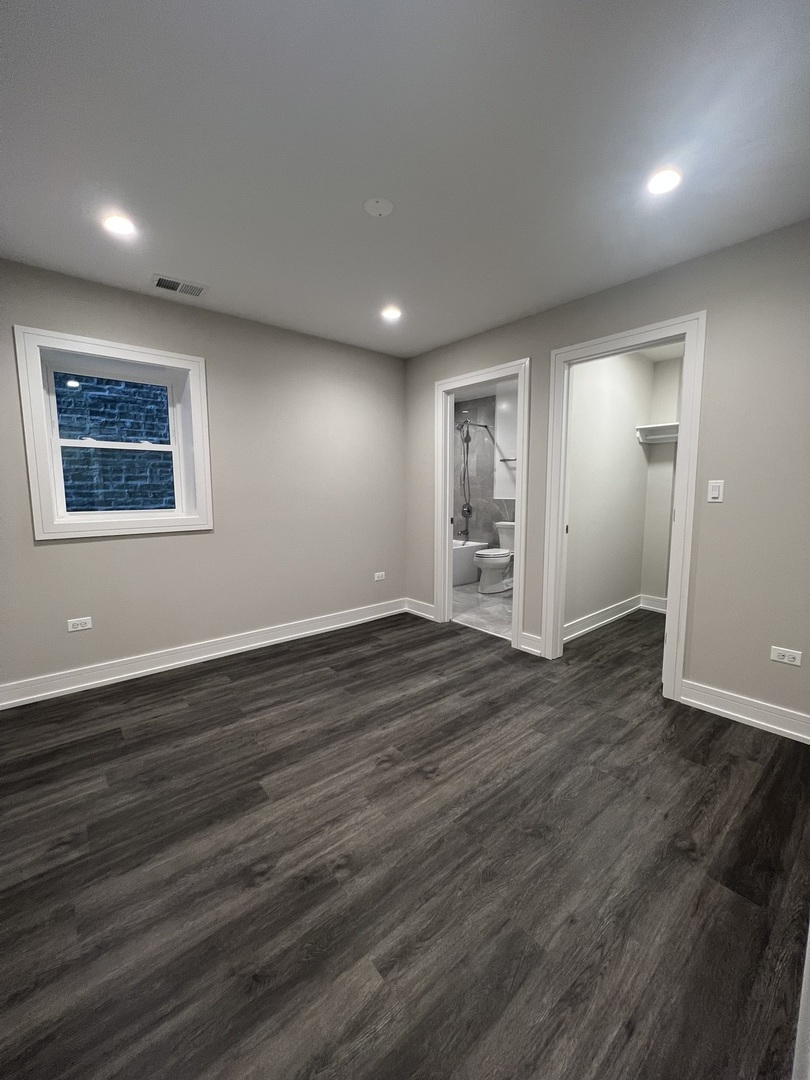 Undisclosed Address Chicago, IL 60640 - Photo 14 of 15 an empty room with wooden floor and windows