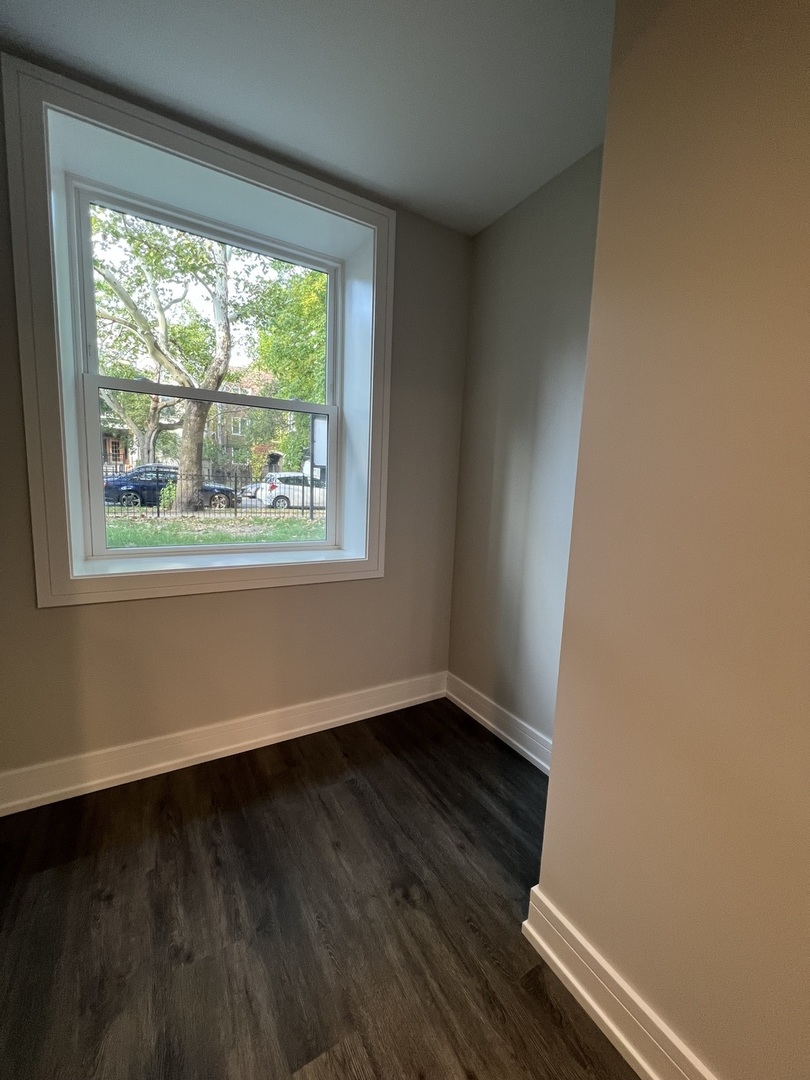 Undisclosed Address Chicago, IL 60640 - Photo 6 of 15 an empty room with wooden floor and windows