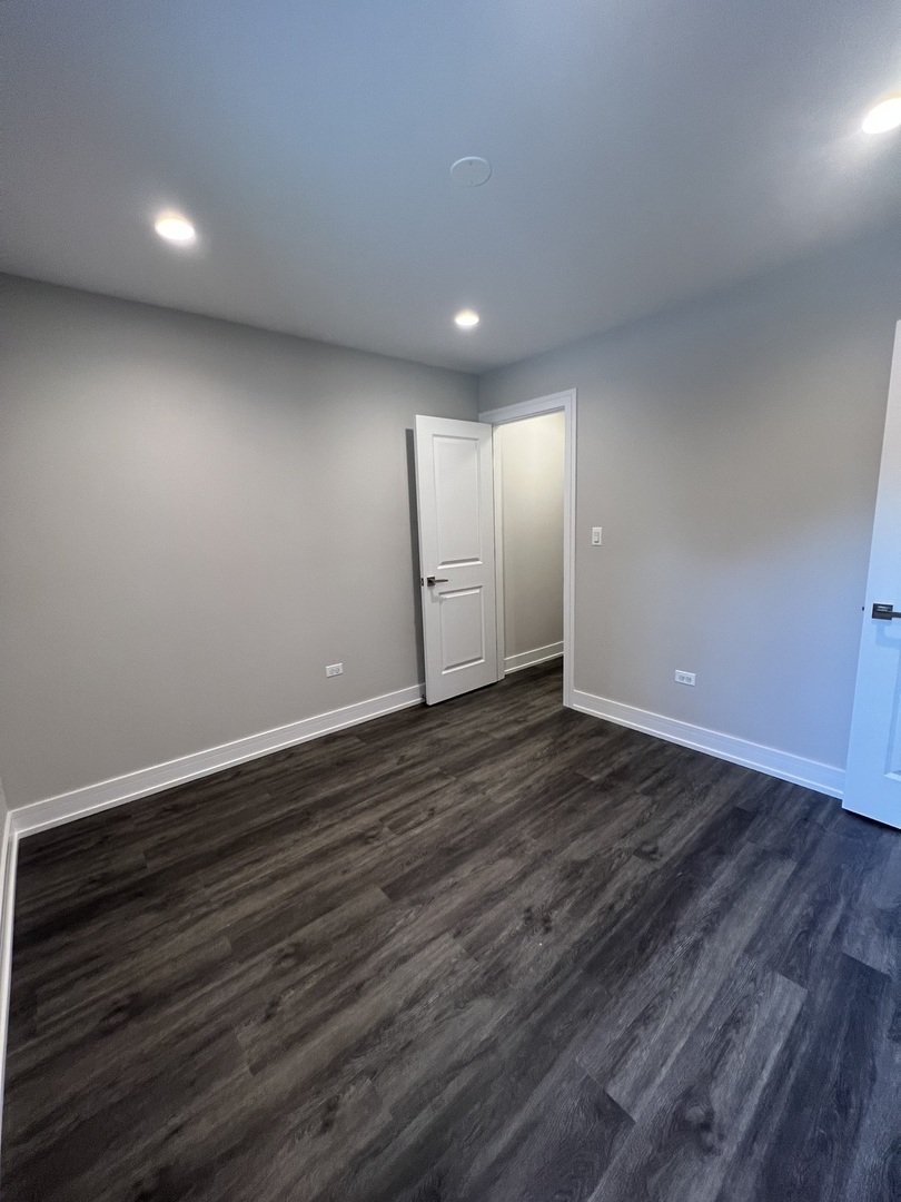 Undisclosed Address Chicago, IL 60640 - Photo 8 of 15 a view of empty room with wooden floor