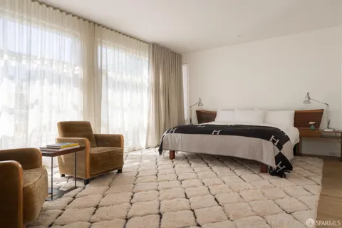 a bedroom with furniture and windows