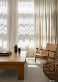 a living room with furniture and white walls