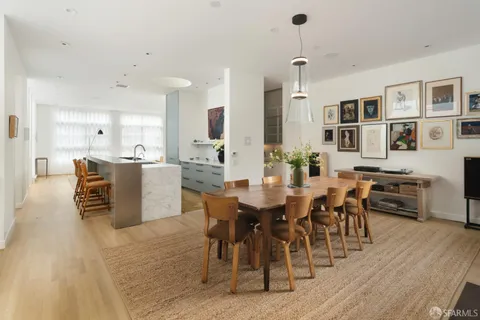 a dining room with furniture a rug and wooden floor