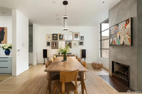 a view of a dining room with furniture wooden floor and a chandelier