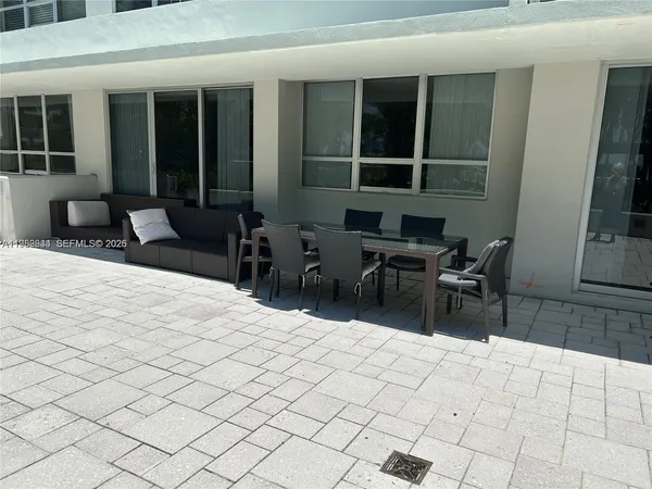 a view of a glass door with a chair