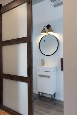a bathroom with a sink toilet and mirror