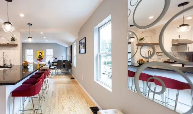 a very nice looking room with many windows and furniture