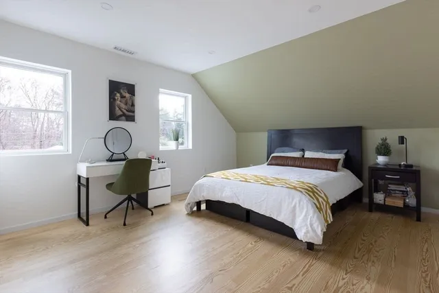 a bedroom with a bed a table and chair