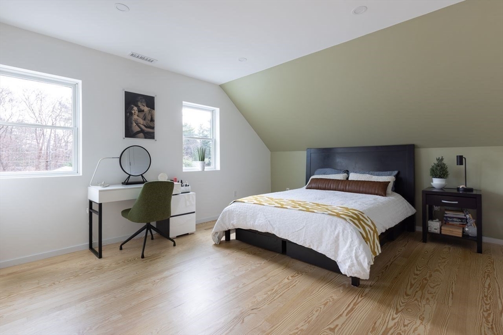 136 Topsfield Road Ipswich, MA 01938 - Photo 7 of 13 a bedroom with a bed a table and chair