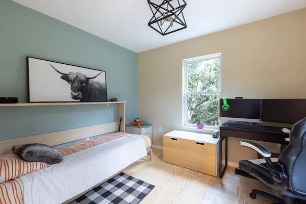 a bedroom with a bed and a window