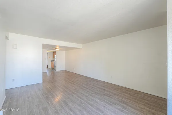 a view of an empty room and wooden floor