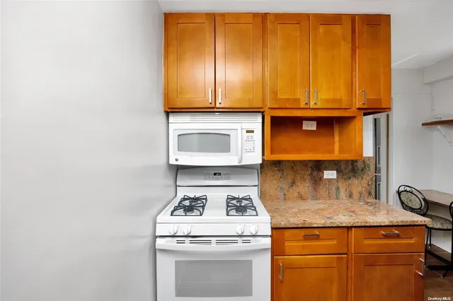 a kitchen with granite countertop cabinets stainless steel appliances and a sink
