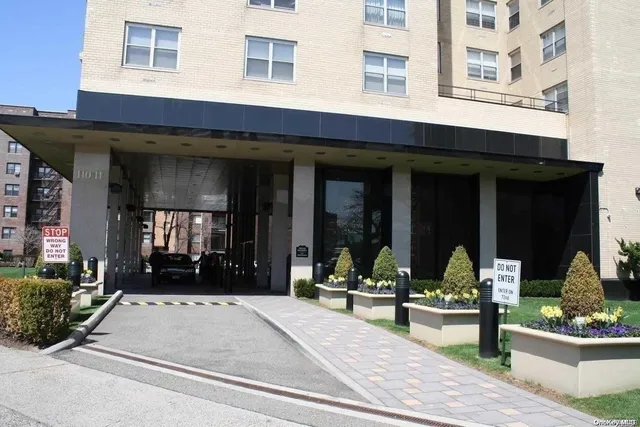 a front view of a building with sitting area