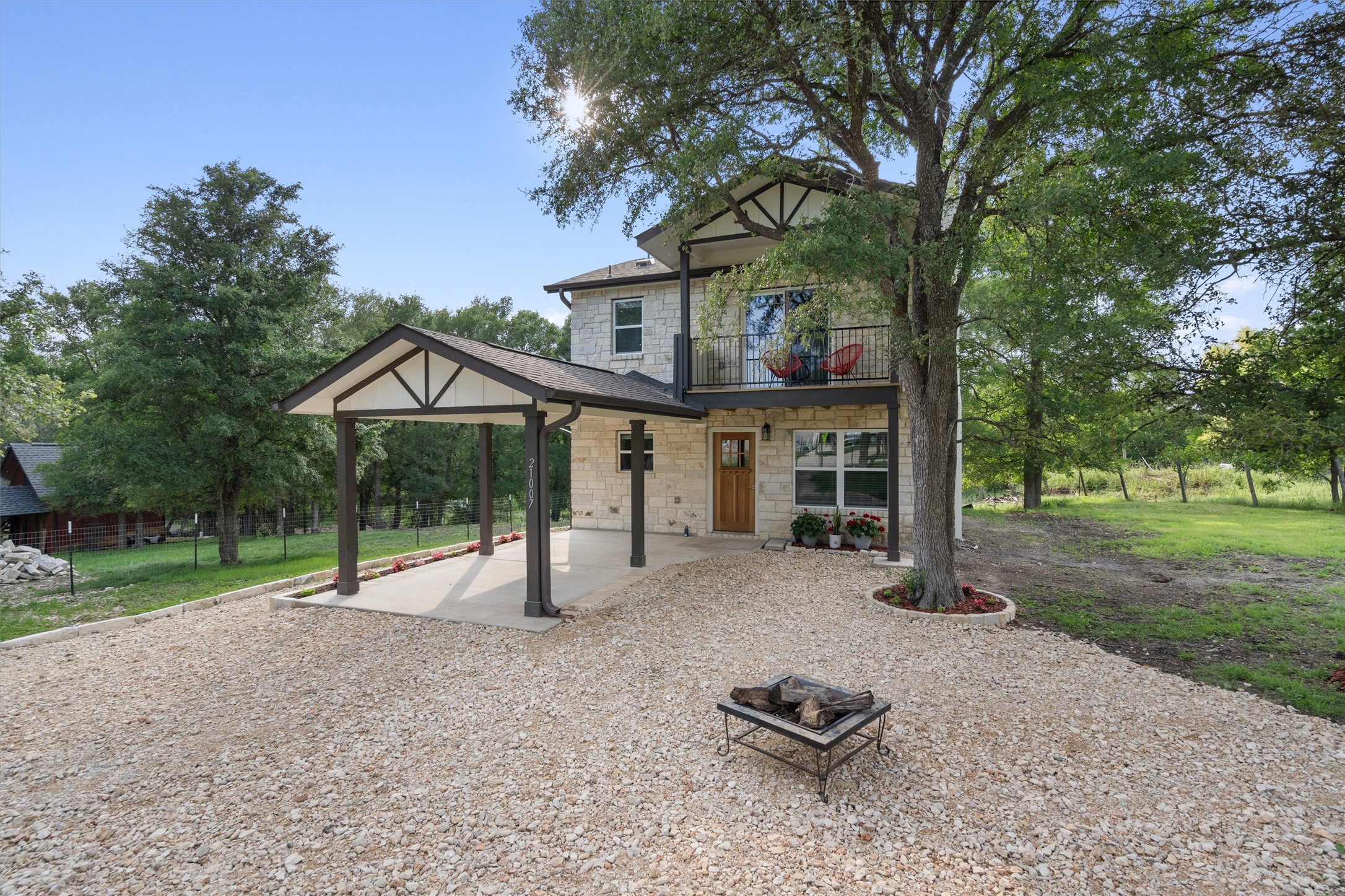 21007 Coleman Branch Creek Road Manor, TX 78653 - Photo 2 of 30 Spacious front yard with natural landscaping and open skies.