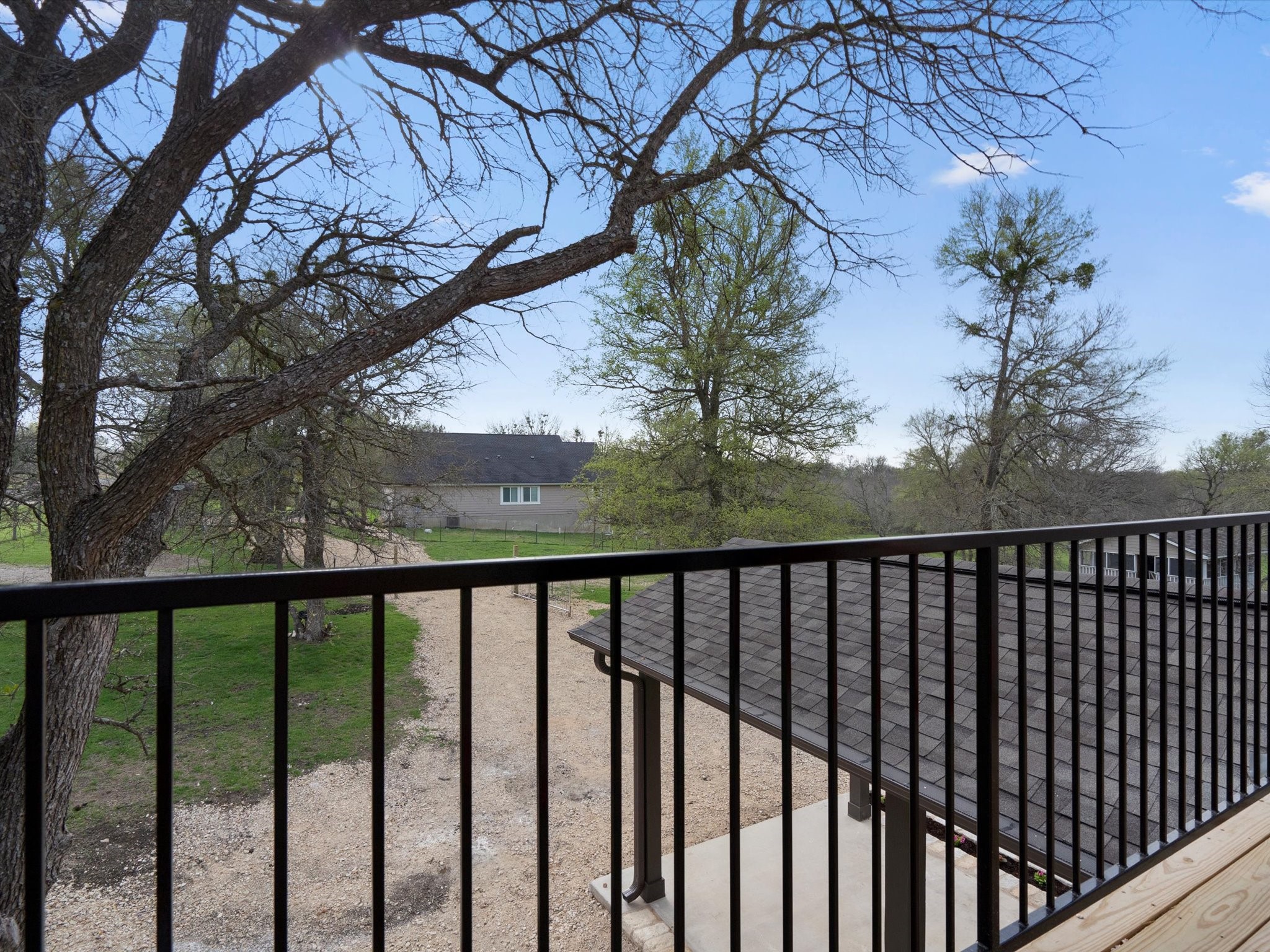 21007 Coleman Branch Creek Road Manor, TX 78653 - Photo 23 of 30 Outdoor balcony overlooking the peaceful landscape.