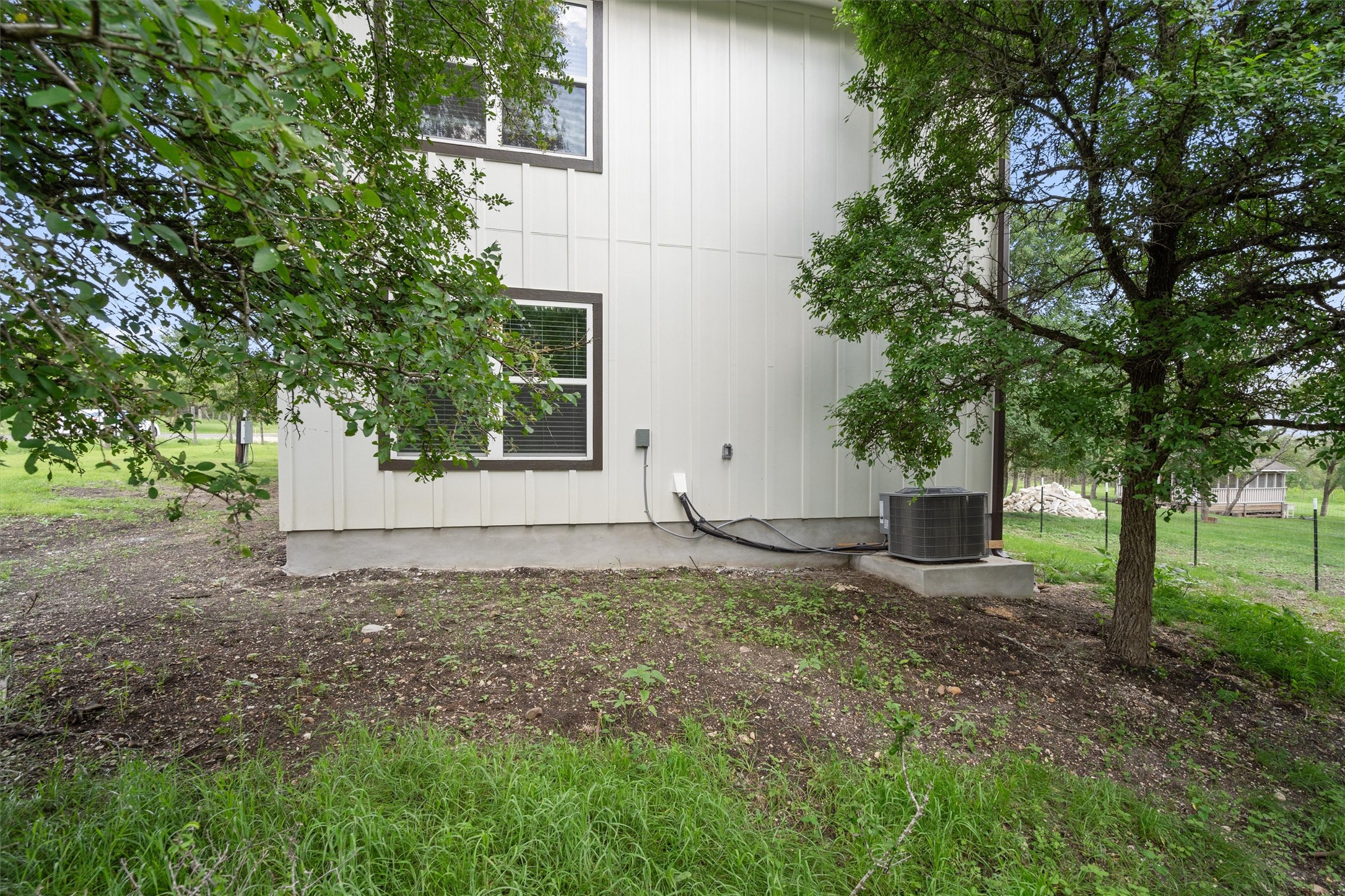 21007 Coleman Branch Creek Road Manor, TX 78653 - Photo 29 of 30 Rear exterior view of the home and surrounding yard.