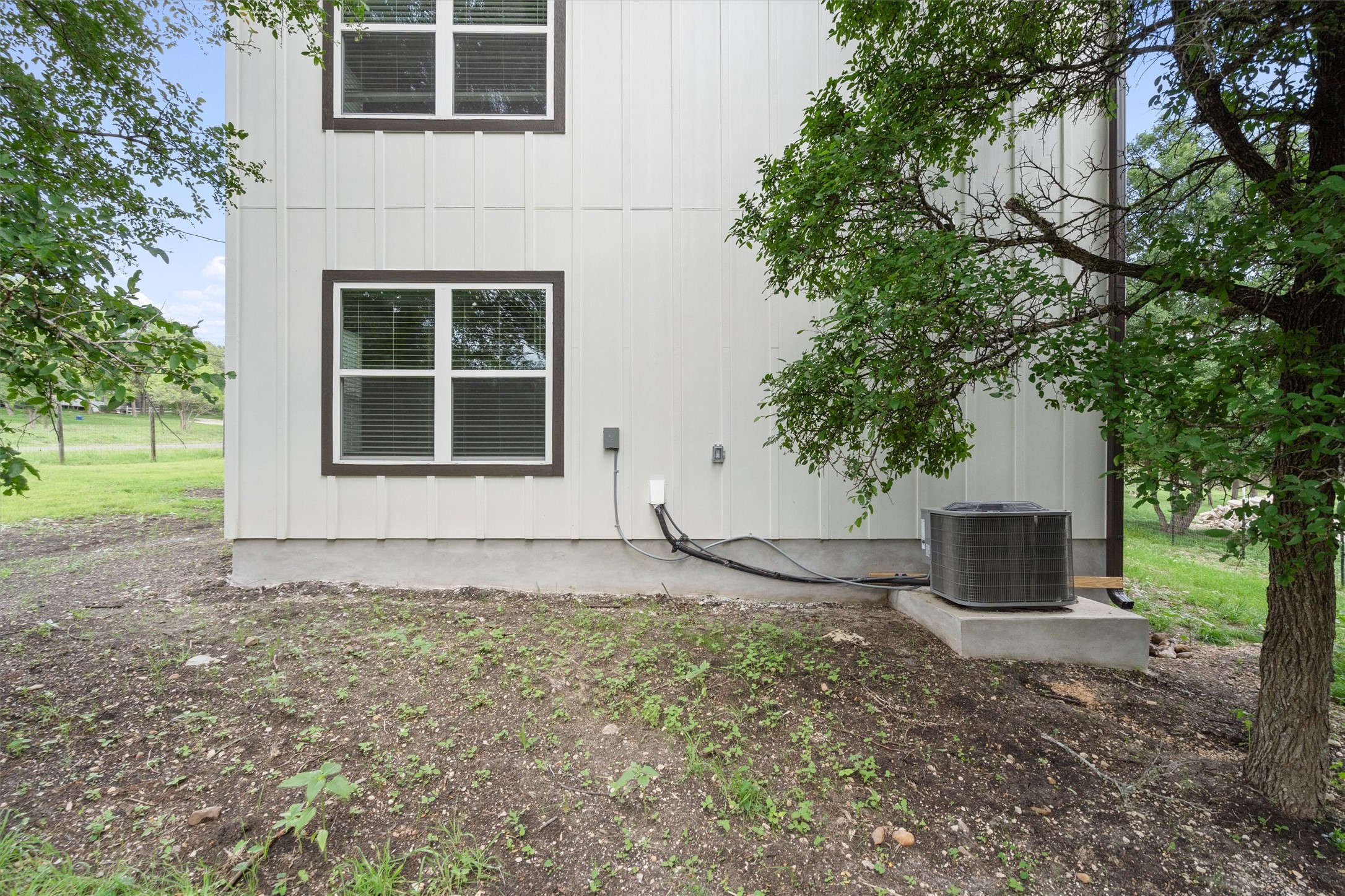 21007 Coleman Branch Creek Road Manor, TX 78653 - Photo 30 of 30 Rear exterior view of the home and surrounding yard.