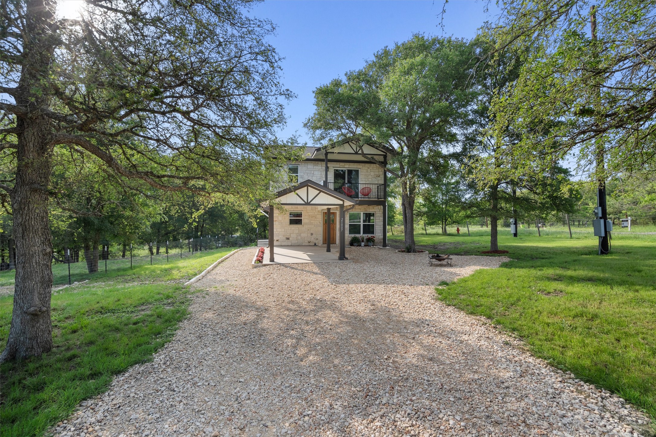 21007 Coleman Branch Creek Road Manor, TX 78653 - Photo 3 of 30 Gravel driveway leading to the home with scenic surroundings.