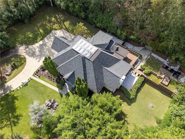 an aerial view of a house with a garden and lake view
