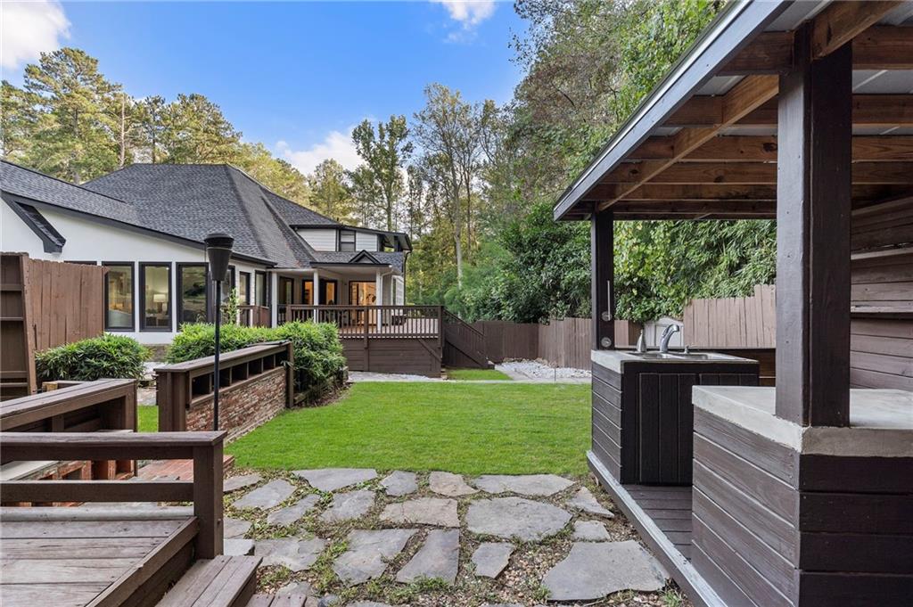 11260 Houze Road Roswell, GA 30076 - Photo 34 of 60 a view of a house with backyard porch and sitting area