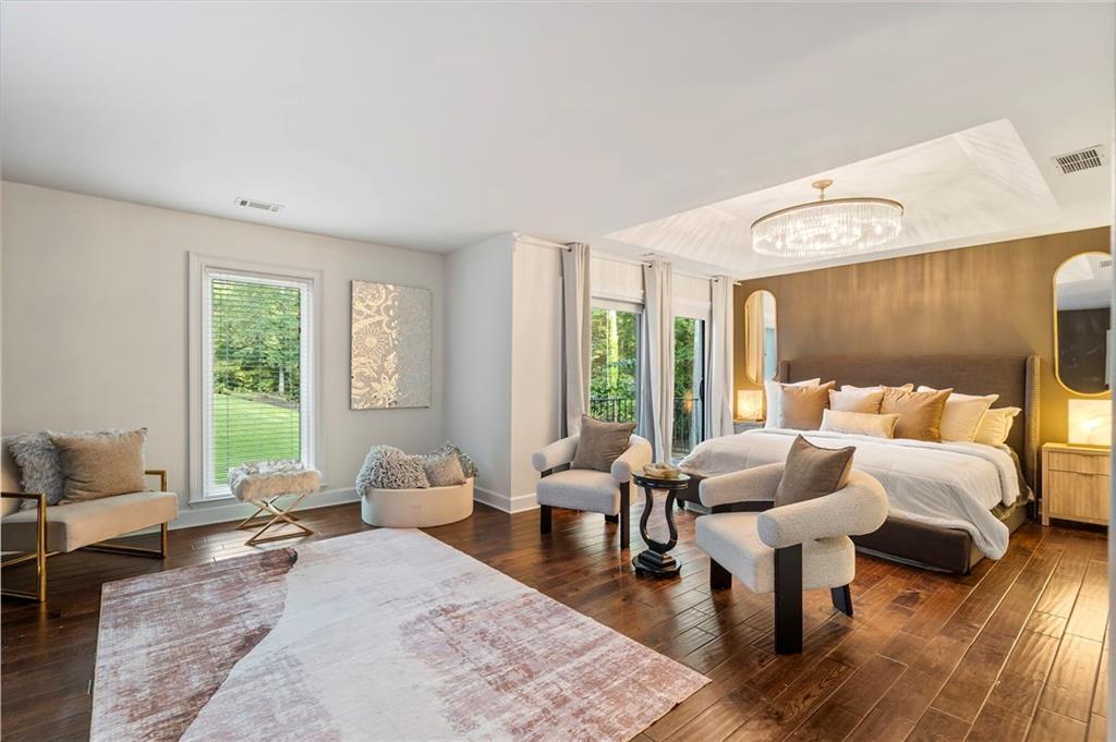 11260 Houze Road Roswell, GA 30076 - Photo 36 of 60 a bedroom with furniture and wooden floor