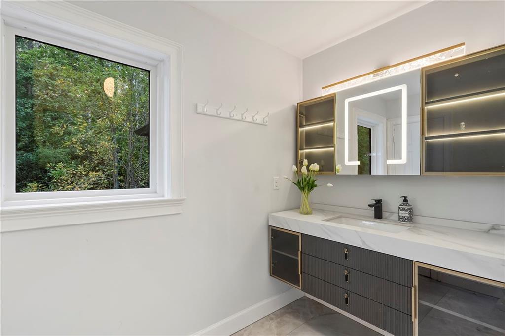 11260 Houze Road Roswell, GA 30076 - Photo 41 of 60 a bathroom with a sink mirror and a window