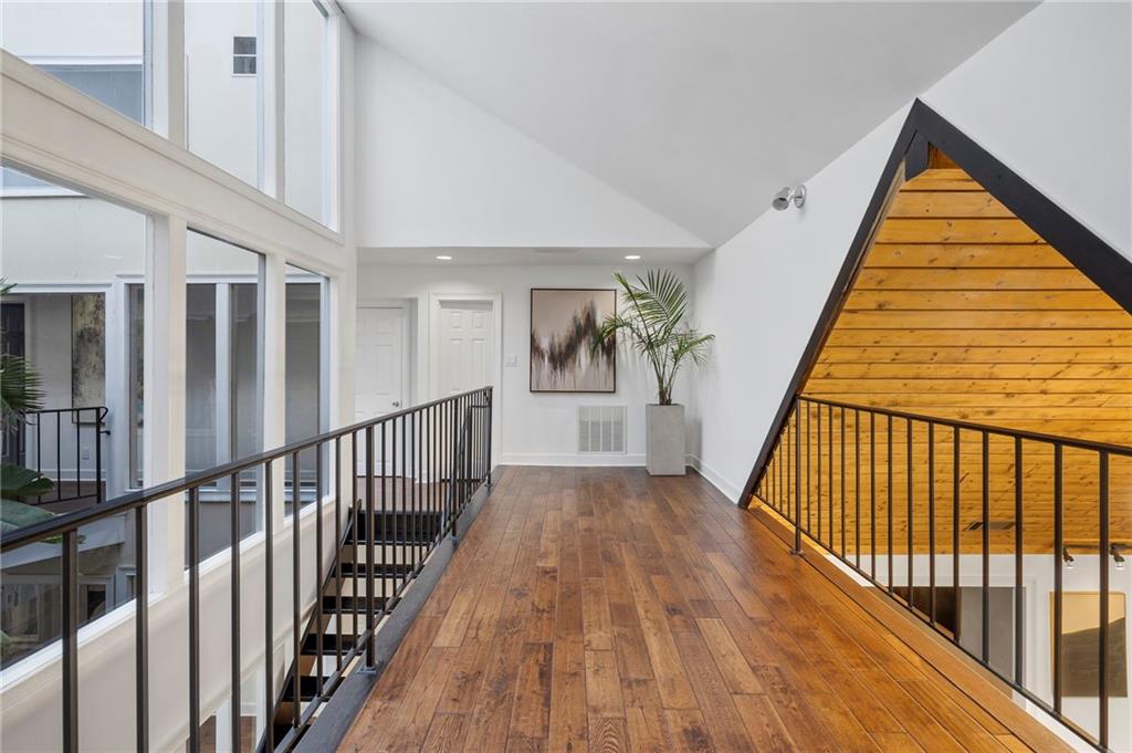 11260 Houze Road Roswell, GA 30076 - Photo 44 of 60 a view of staircase with wooden floor and a front door