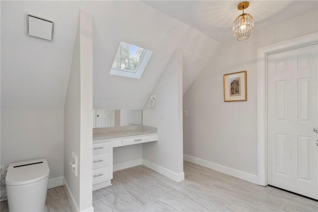 11260 Houze Road Roswell, GA 30076 - Photo 52 of 60 a view of bathroom with a toilet a sink and a mirror