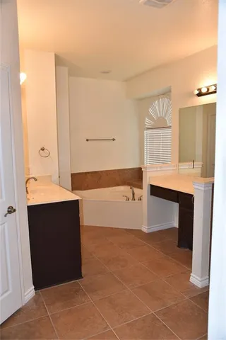 a view of kitchen with cabinets and window