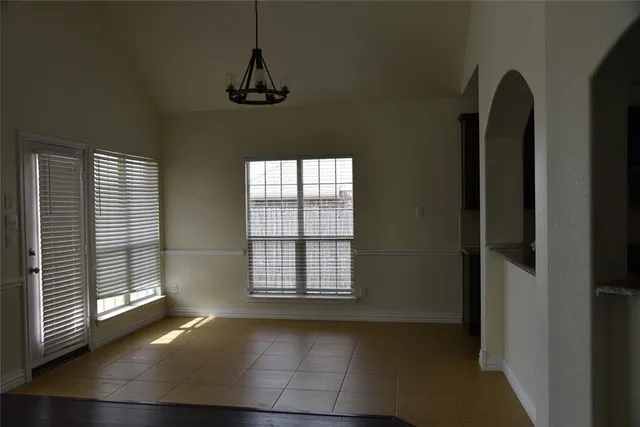 a view of an empty room with windows