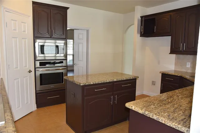 a kitchen with a stove microwave and refrigerator