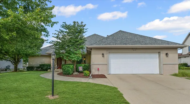 a front view of house with a garden