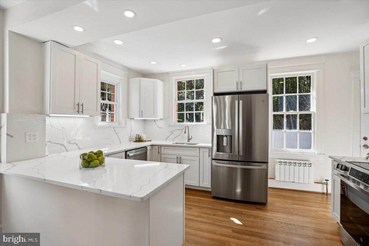 4714 Hunt Avenue Chevy Chase, MD 20815 - Photo 15 of 54 a kitchen with granite countertop a refrigerator and a sink