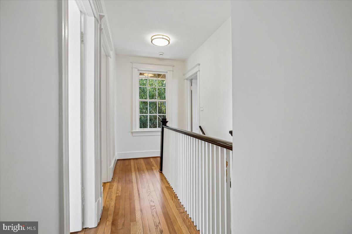 4714 Hunt Avenue Chevy Chase, MD 20815 - Photo 17 of 54 a view of a hallway with wooden floor and staircase