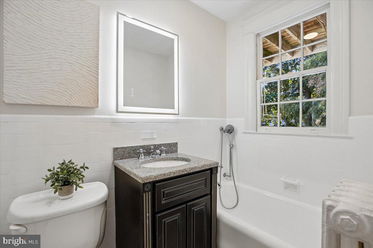 4714 Hunt Avenue Chevy Chase, MD 20815 - Photo 20 of 54 a bathroom with a sink toilet and shower