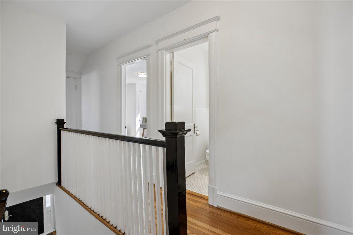 4714 Hunt Avenue Chevy Chase, MD 20815 - Photo 23 of 54 a view of a hallway with wooden floor and staircase