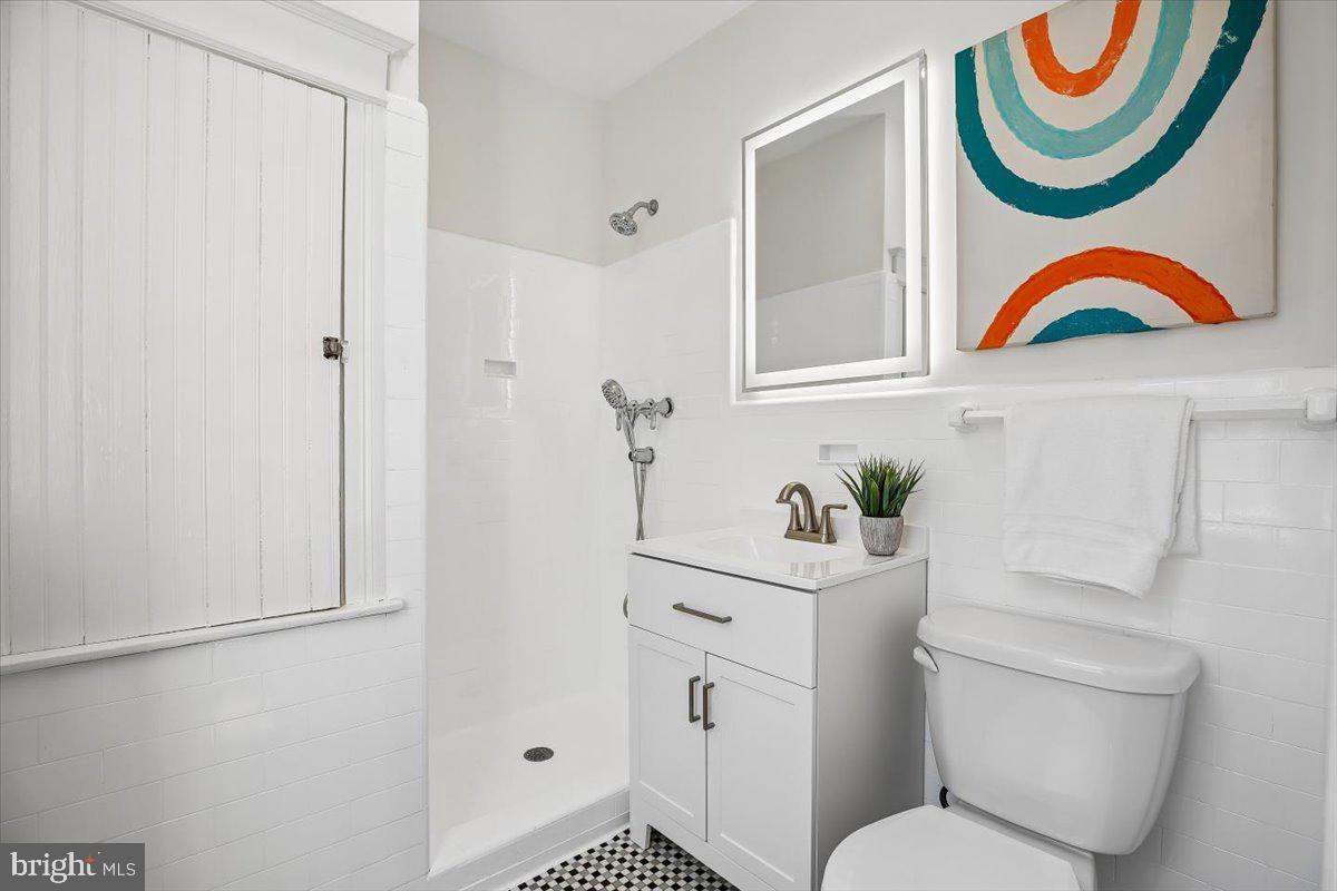 4714 Hunt Avenue Chevy Chase, MD 20815 - Photo 25 of 54 a bathroom with a sink and mirror with toilet