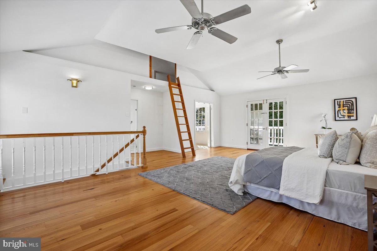 4714 Hunt Avenue Chevy Chase, MD 20815 - Photo 27 of 54 a bedroom with a large bed and a wooden floor