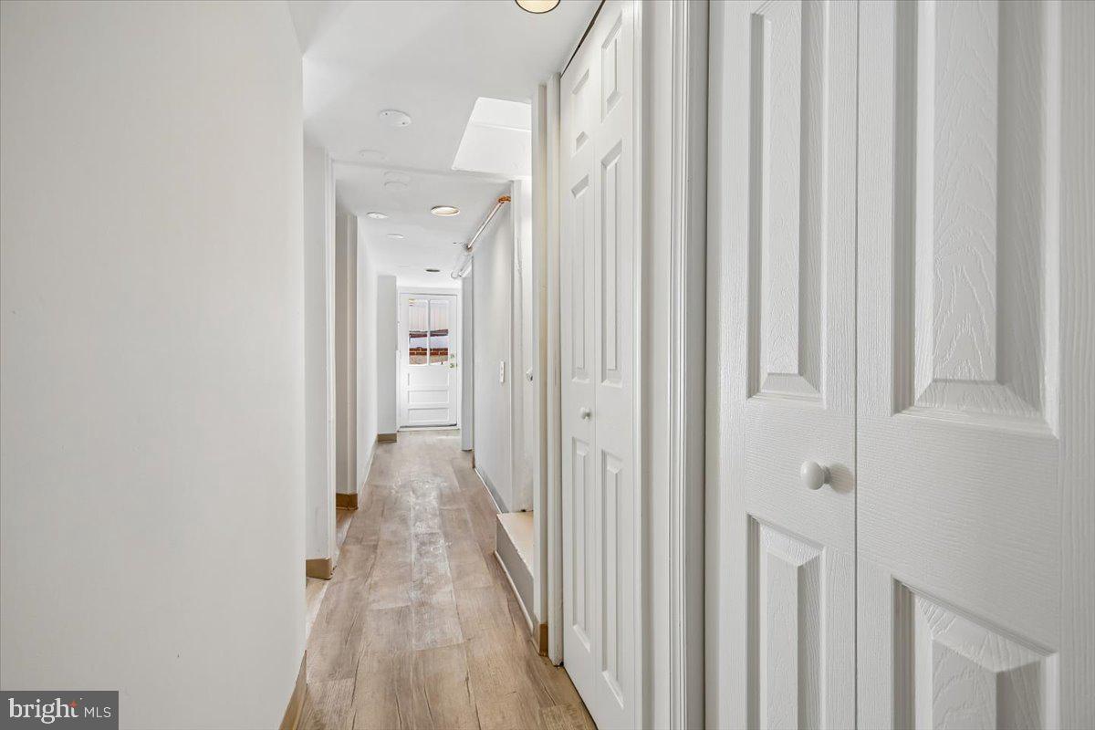 4714 Hunt Avenue Chevy Chase, MD 20815 - Photo 44 of 54 a view of a hallway with wooden floor and a curtain