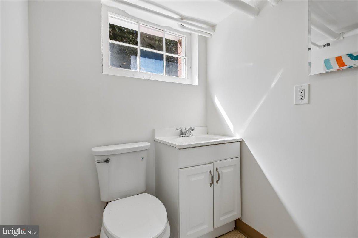 4714 Hunt Avenue Chevy Chase, MD 20815 - Photo 45 of 54 a utility room with a sink a toilet and wooden floor