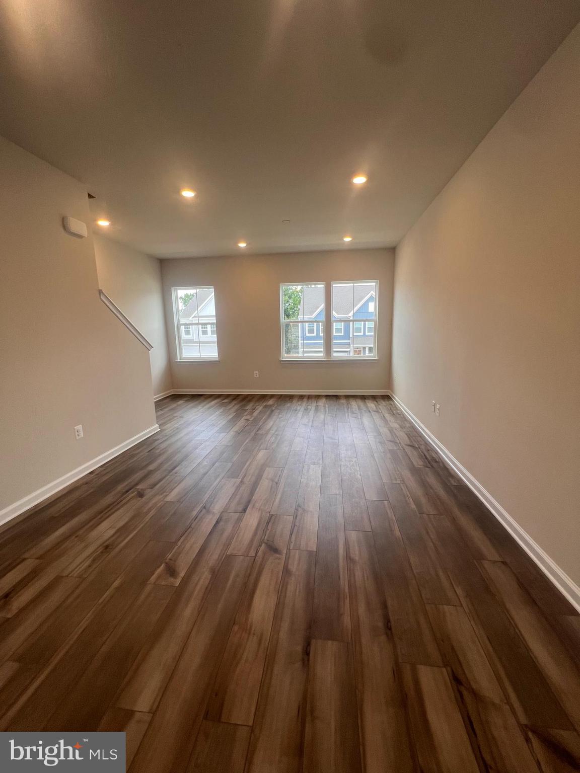 311 Sandy Btm Circle Ranson, WV 25438 - Photo 19 of 33 an empty room with wooden floor and windows